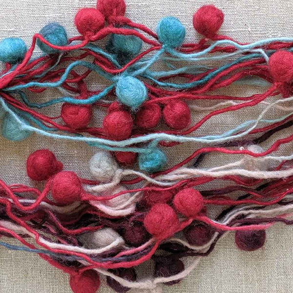art yarn with pompoms