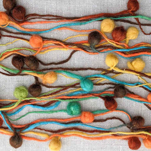 multicolour pompoms on a string