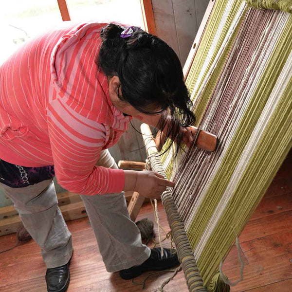 woman hand weaving rug in Chile