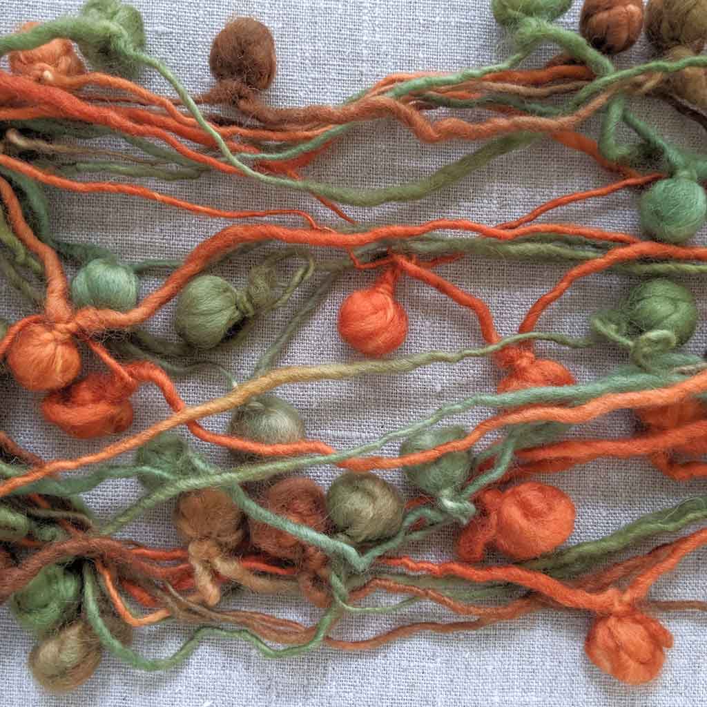 yarn pom poms green orange
