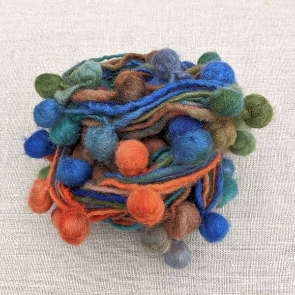 yarn with pompoms blue